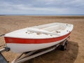 a boat on land with white and red colors of pinturay on its cart of extractiona boat on land with white and red paint colors and Royalty Free Stock Photo