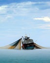 A large fishing boat in the middle of the sea.