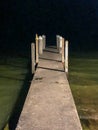 Boat launch pier in water at night Royalty Free Stock Photo