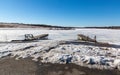 Boat launch ramp at frozen lake with traffic marks on frozen lake surface