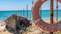 Boat, rescue circle of an old boat, on the sand against the sea with ropes and blue sky Royalty Free Stock Photo