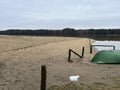 A boat lying upside down on the beach of a small lake in early spring after the snow and ice have gone Royalty Free Stock Photo