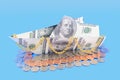 Boat made of money on a blue background