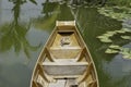 The boat made of wood floating on the water in the lotus pond Royalty Free Stock Photo
