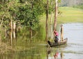 Boat with a man and children in the river in jungle, Cambodia