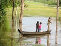 Boat with a man and children in the river in jungle, Cambodia