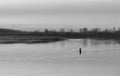 A boat, a man, the Po near Cremona, Italy. Royalty Free Stock Photo