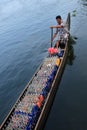 A boat man transport soft drink bottles in his boat