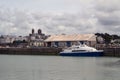 Harbor landscape of a town in Normandy with a passenger transport boat