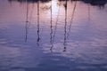 Sunset with boats mast and reflection