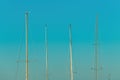 Boat masts against blue sky