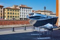 Boat with mirror silver surface near the Santa Cristina Roman Catholic church in Pisa