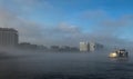 Boat in the mist in Amsterdam harbor Royalty Free Stock Photo