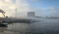 Boat in the mist in Amsterdam harbor Royalty Free Stock Photo