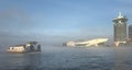 Boat in the mist in Amsterdam harbor Royalty Free Stock Photo