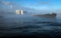 Boat in the mist in Amsterdam harbor Royalty Free Stock Photo