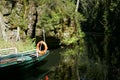 Boat moored at river bank in forest