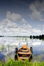 Boat moored rubber tires cloud reflection on water Royalty Free Stock Photo