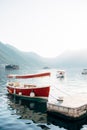 Boat is moored to the pier overlooking the small islands in the Bay of Kotor Royalty Free Stock Photo