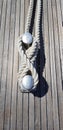 Boat mooring bollard with rope, wooden deck Royalty Free Stock Photo