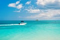 Boat with motor cruising on turquoise sea surface