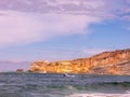 View of the ocean, a cliff and a boat in nazare, portugal