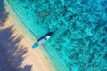 Boat near beach from top view. Turquoise water background from top view. Summer seascape from air. Gili Meno island, Indonesia. Royalty Free Stock Photo