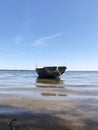 A boat with networks on the shore of the lake. Lake Naroch