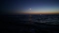 boat at night at sea under the moon Royalty Free Stock Photo