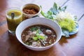 Boat noodles,Thai style noodle soup or noodles with pork and pork balls, Close up or selective focus and garnish set for Thai