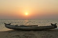 Boat on the ocean shore at sunset. Kerala, India