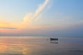 Boat in the ocean at sunrise Royalty Free Stock Photo