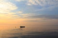 Boat in the ocean at sunrise Royalty Free Stock Photo