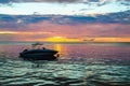 Boat in the ocean at sunset