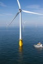 Boat in offshore windfarm Royalty Free Stock Photo