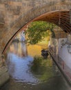 boat and old houses under Charles Bridge in the narrow river Devil (Czertovka), Prague Royalty Free Stock Photo