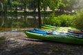 Boat parking on the river bank on a sunny summer day. Rental kayaks, boats in the park