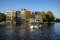 Typical Dutch mansion houses on a canal in autumn light in Amsterdam