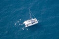 Boat and people swimming in the highest sea cliff in Europe at 1,903 feet 580 meters above the sea. Cabo GirÃÂ£o bay Royalty Free Stock Photo