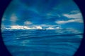 Boat porthole with ocean view close up