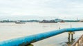 Boat pull barge full of coal cruising Mahakam River in front of Samarinda Great Mosque.