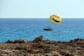 A Boat Pulls Colorful Para Sailing At The Blue Sea