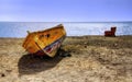 A Boat and a Recliner on the Shore at Pouerto Puerto de Mogan on Gran Canaria, Spain Royalty Free Stock Photo