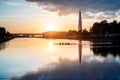 Boat regatta/rowing team silhouette on the tranquil lake at sunset Royalty Free Stock Photo