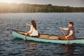 Boat rides equal fun times. a young couple rowing a boat out on the lake. Royalty Free Stock Photo