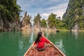 Boat riding through with woman tourist at Sam Klur mountain Khaosok National Park, Surat Royalty Free Stock Photo