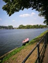 Boat on the river surrounded by greens under the blue sky