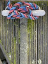 Boat rope tied on pier bollard on wooden pier Royalty Free Stock Photo