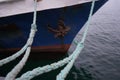 Boat ropes, ship. Lots of rope knots leading to moored ships. Mooring post on the waterfront , element for mooring ships