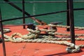 Boat ropes tied around a hawser or bollard on the deck of a fishing boat